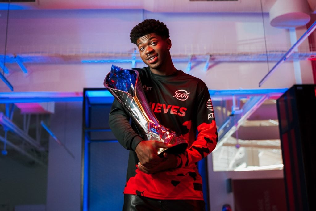Lil Nas X holding LCS trophy