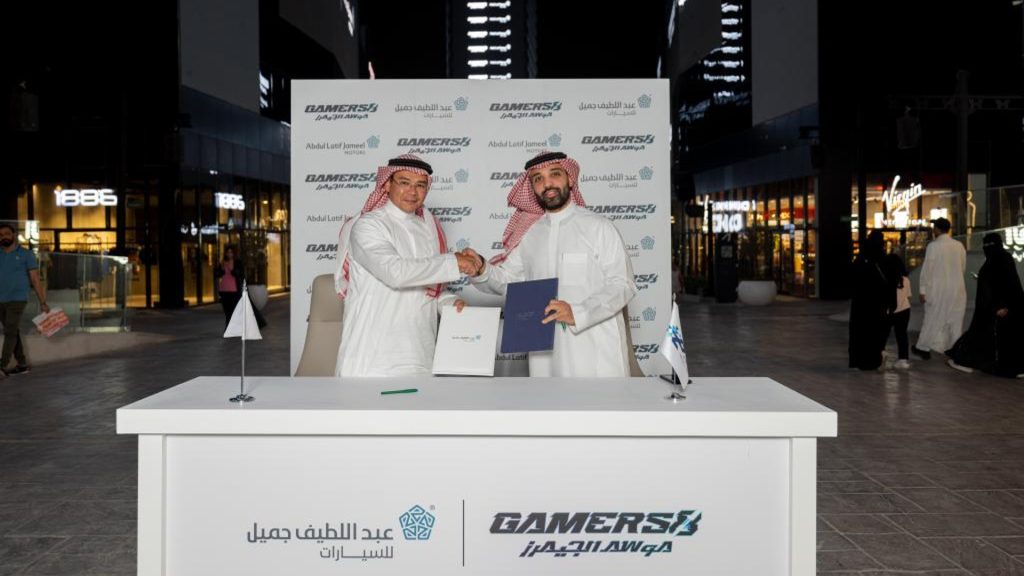 Screenshot of two people holding a contract between Gamers8 and Abdul Latif Jameel Motors
