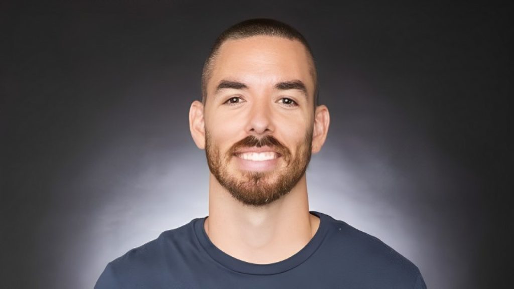 Riot Games Marc Merril  smiling on white and grey background