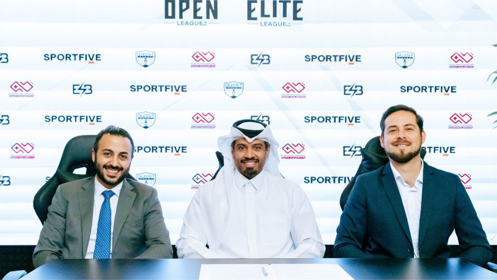 Image of ESB and Qatar Esports Federation representatives sat at desk with logos in background